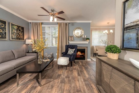 a living room with a couch and a chair and a fireplace